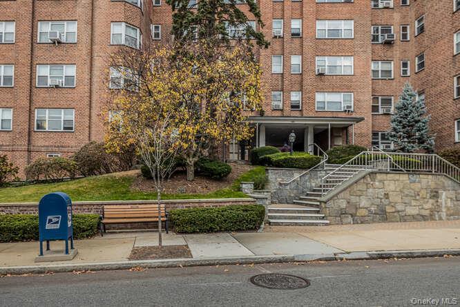 235 Garth Road, Unit E5I Scarsdale, NY 10583 - Photo 20 of 22 a view of a brick building and large windows