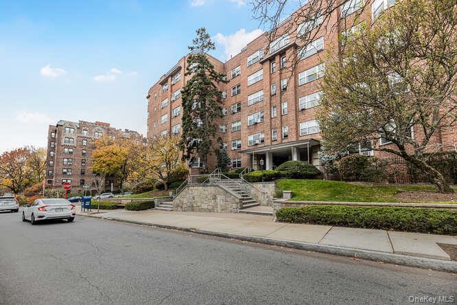 235 Garth Road, Unit E5I Scarsdale, NY 10583 - Photo 21 of 22 a view of a street with a cars parked in front of it