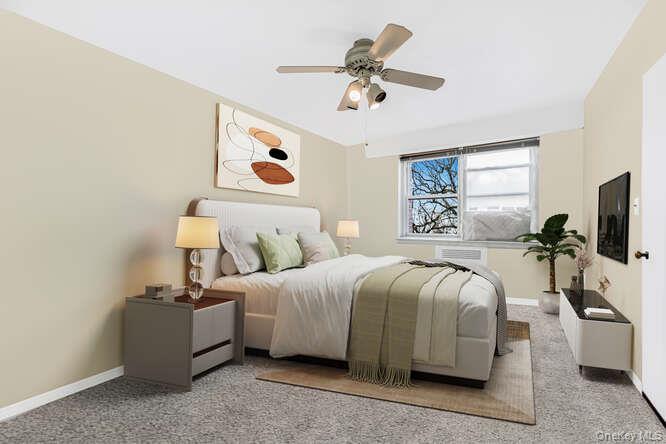 235 Garth Road, Unit E5I Scarsdale, NY 10583 - Photo 6 of 22 a bedroom with a bed and a chandelier