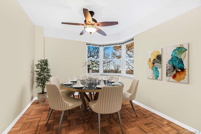 235 Garth Road, Unit E5I Scarsdale, NY 10583 - Photo 9 of 22 a dining room with furniture a window and a chandelier