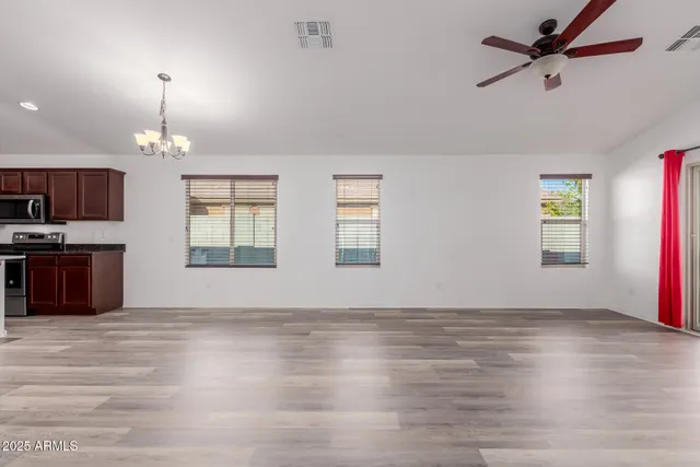 wooden floor chandelier and windows in a room