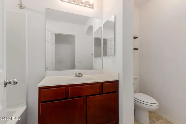 a bathroom with a sink a toilet a mirror and shower