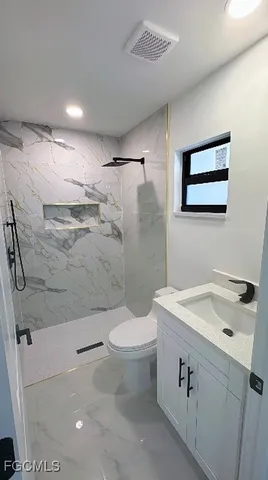 a kitchen with stainless steel appliances a refrigerator and a stove top oven