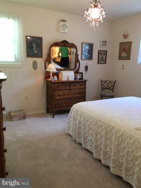 28 South Ritters Lane Owings Mills, MD 21117 - Photo 13 of 30 a bedroom with a bed and a flat tv screen on dresser