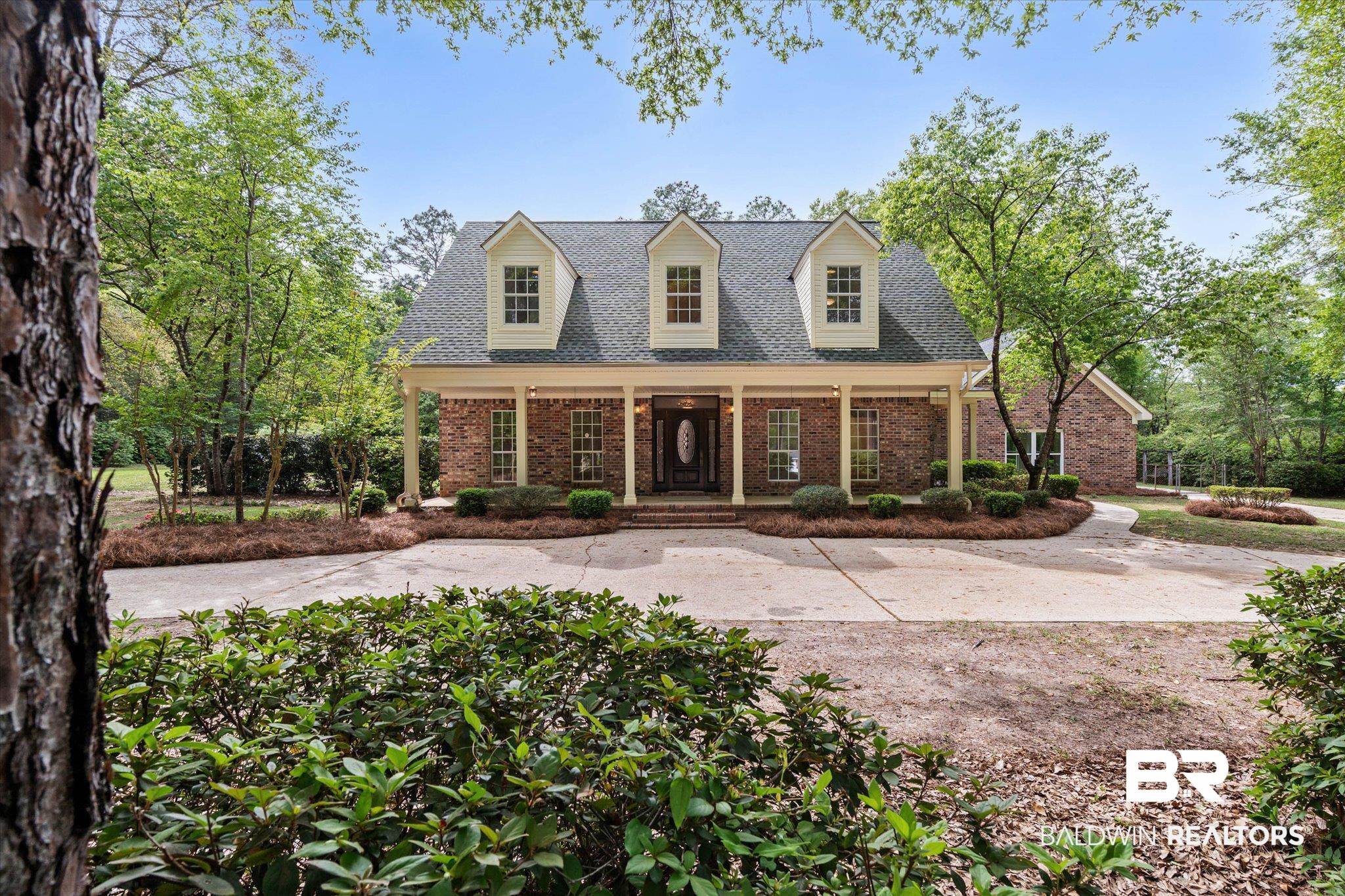 3451 Lacoste Road Mobile, AL 36618 - Photo 1 of 36 Cape cod house featuring covered porch, brick siding, and a shingled roof