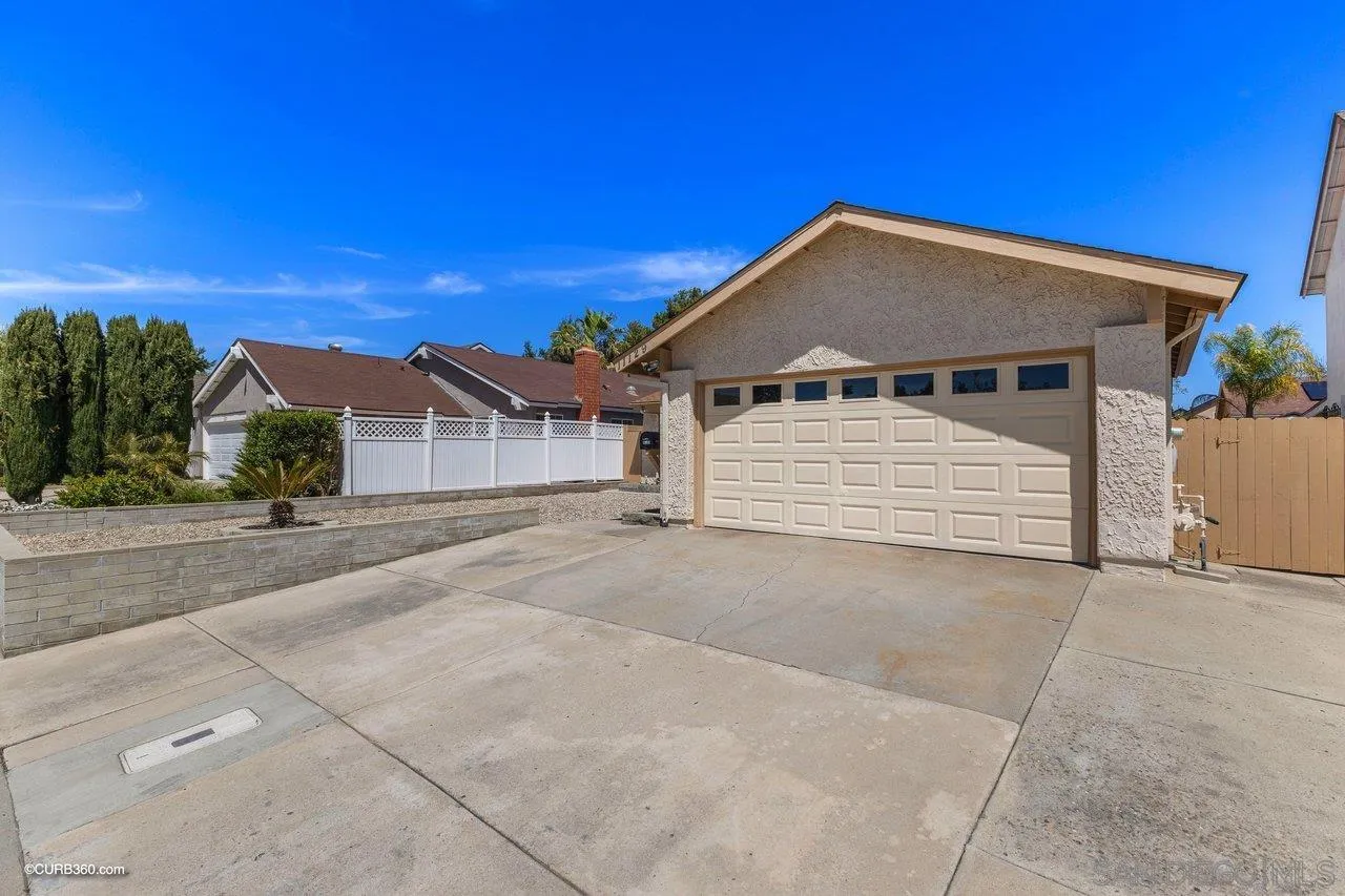 11129 Sagittarius Road San Diego, CA 92126 - Photo 2 of 8 a front view of a house with a yard