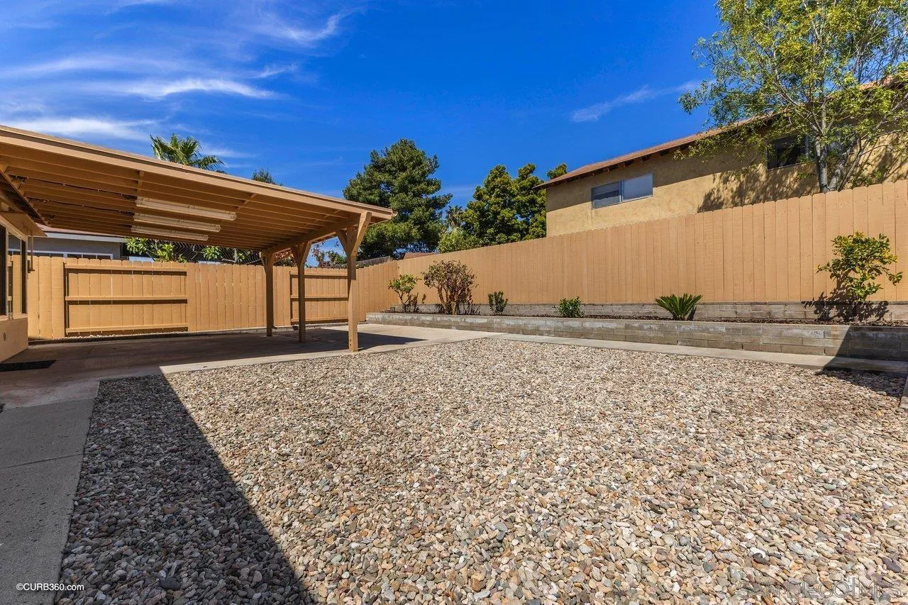 11129 Sagittarius Road San Diego, CA 92126 - Photo 4 of 8 a backyard of a house with lots of green space