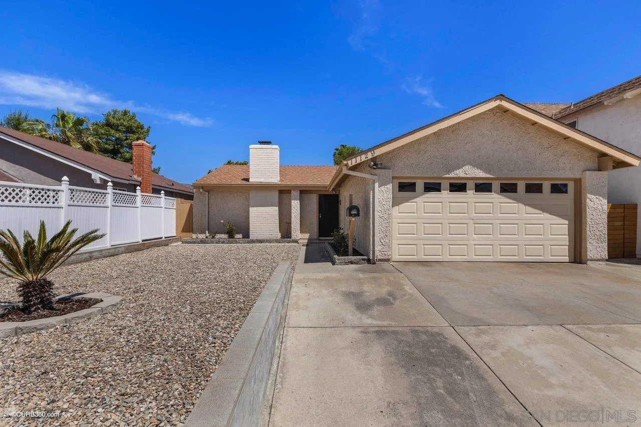 11129 Sagittarius Road San Diego, CA 92126 - Photo 7 of 8 a view of a house with a yard and potted plants