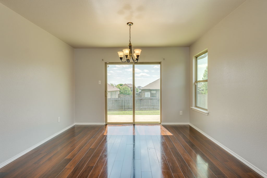 210 Cushman Drive Kyle, TX 78640 - Photo 7 of 21 Rich wood-finish flooring complements light-toned walls