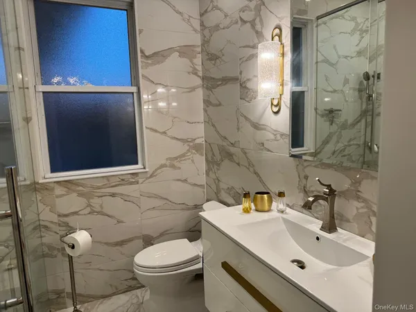 a bathroom with a sink toilet and shower