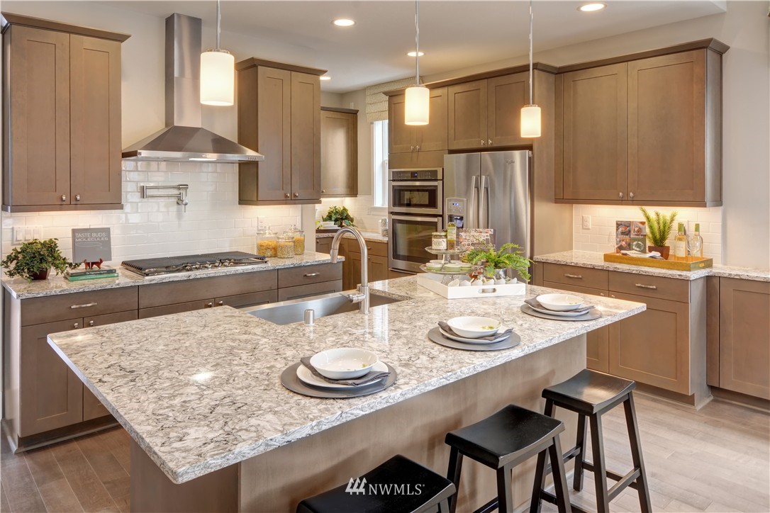 258 Field Place Southeast Renton, WA 98059 - Photo 2 of 19 a kitchen with stainless steel appliances granite countertop a table chairs and stove