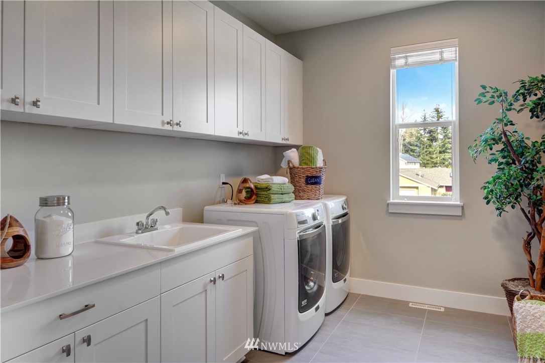 258 Field Place Southeast Renton, WA 98059 - Photo 14 of 19 a utility room with sink dryer and washer