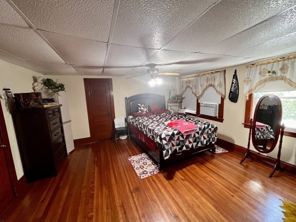 23 Webster Avenue West Springfield, MA 01089 - Photo 6 of 13 a bedroom with a bed and wooden floor