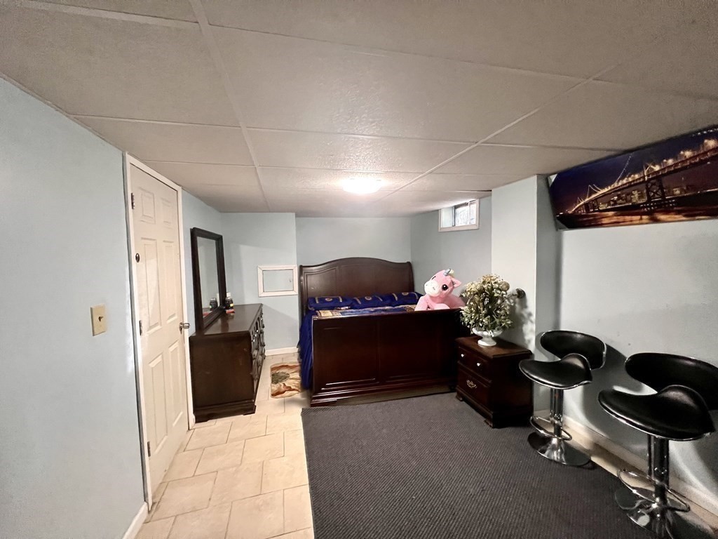 23 Webster Avenue West Springfield, MA 01089 - Photo 8 of 13 a living room with furniture gym equipment and a refrigerator