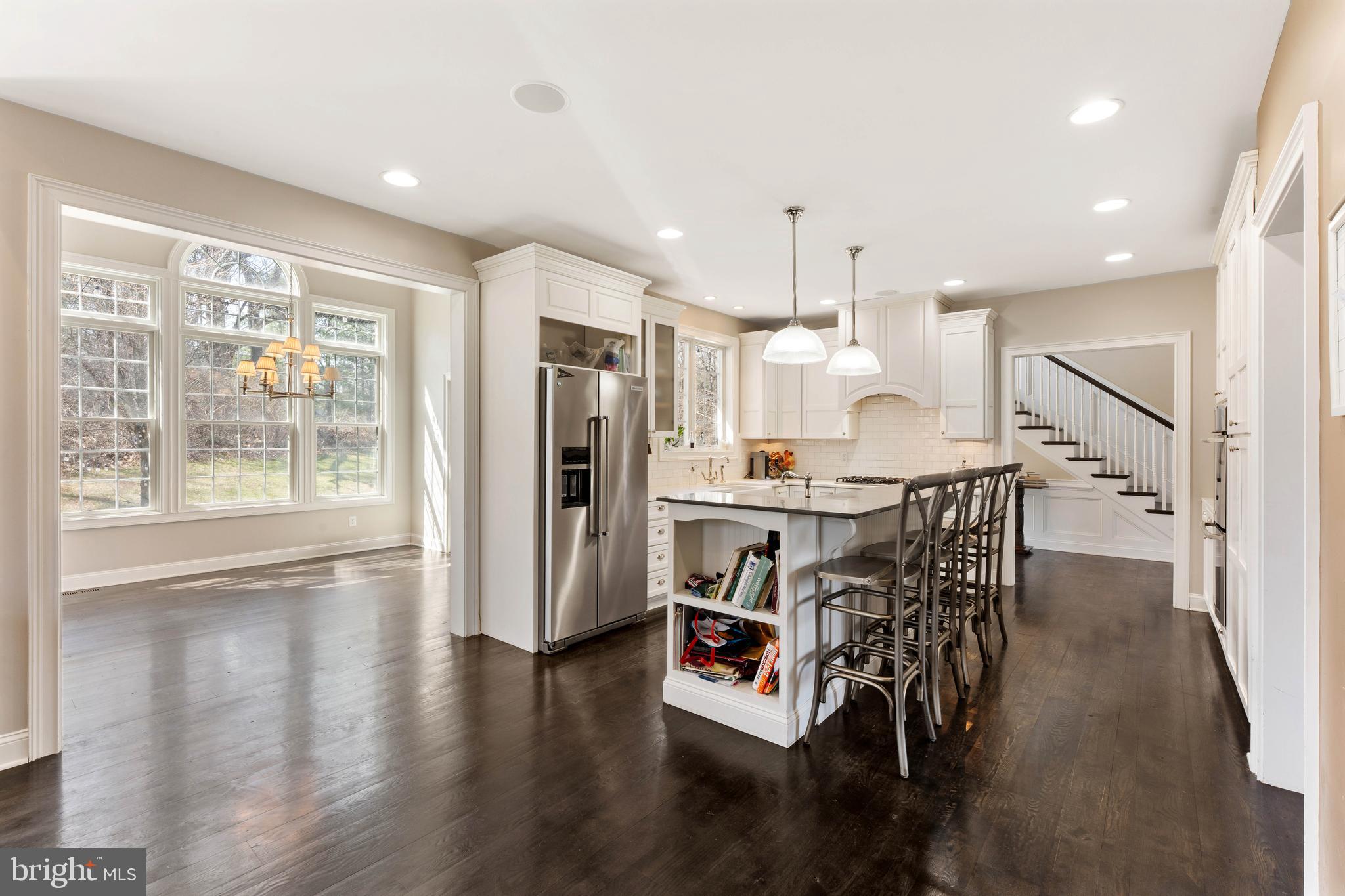 8 Quartermaster Road Feasterville-Trevose, PA 19053 - Photo 13 of 60 a kitchen with stainless steel appliances kitchen island granite countertop a refrigerator a stove a dining table and chairs with wooden floor