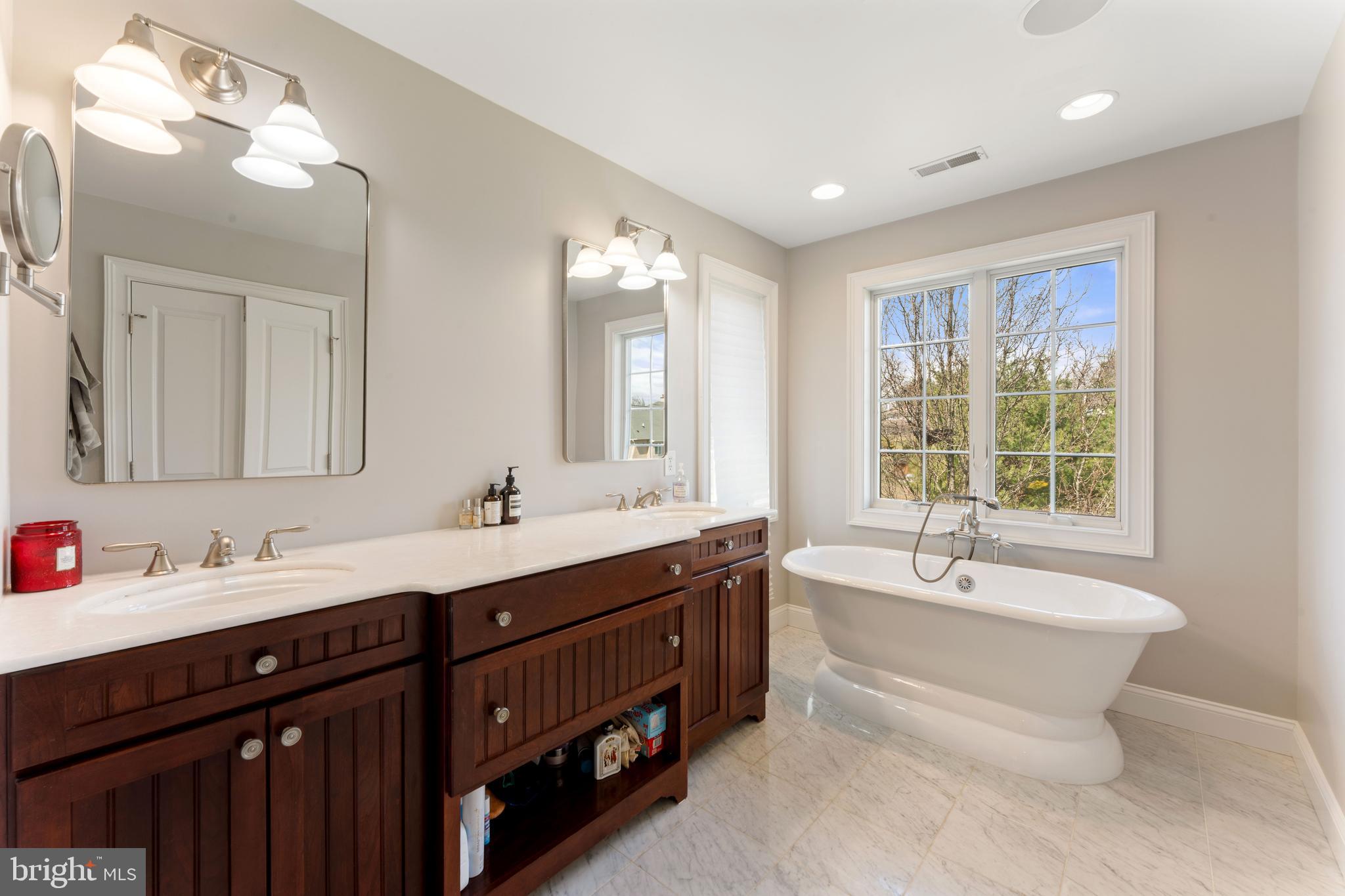 8 Quartermaster Road Feasterville-Trevose, PA 19053 - Photo 30 of 60 a spacious bathroom with a double vanity sink large mirror and a bathtub