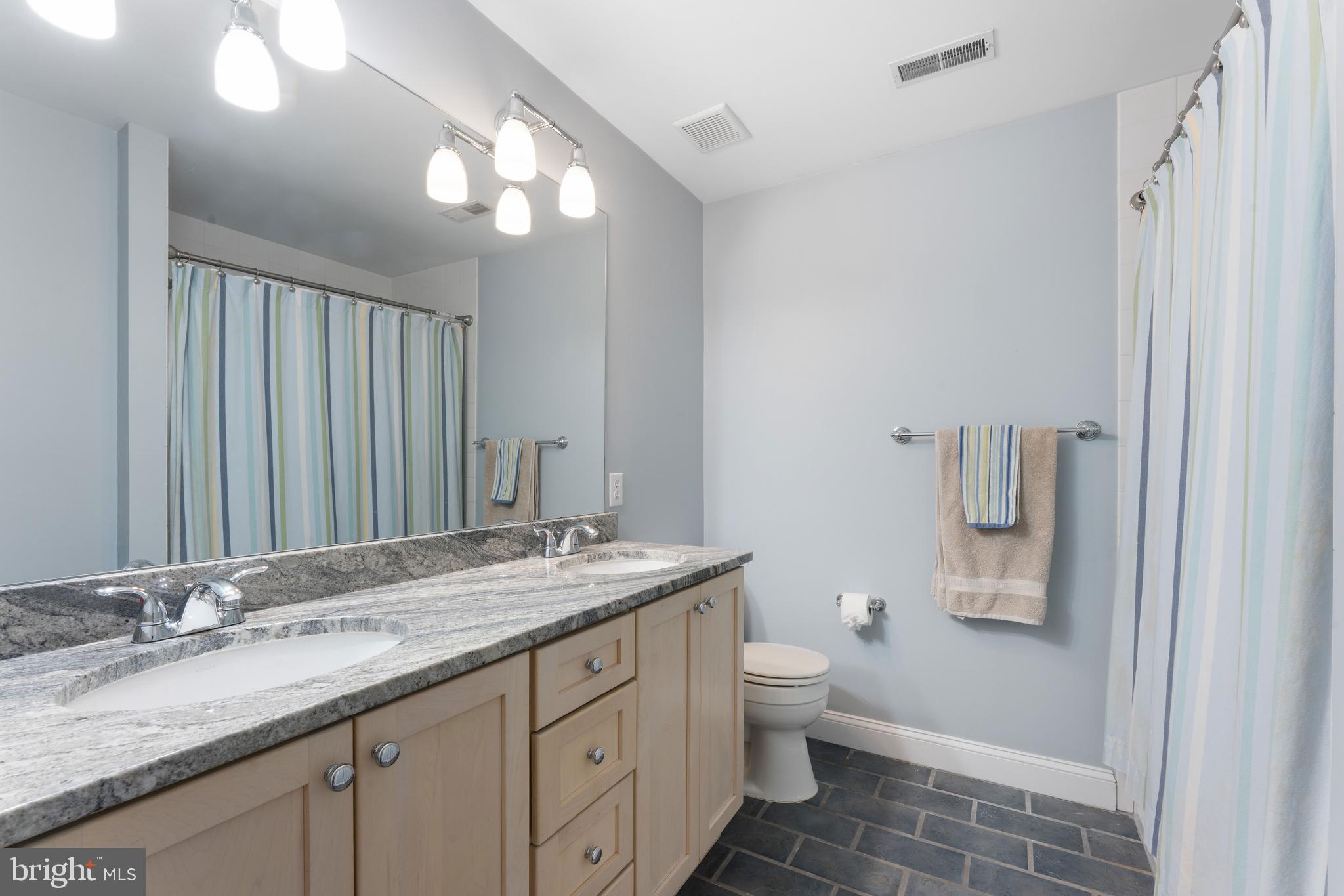 8 Quartermaster Road Feasterville-Trevose, PA 19053 - Photo 43 of 60 a bathroom with a granite countertop sink a toilet and a mirror