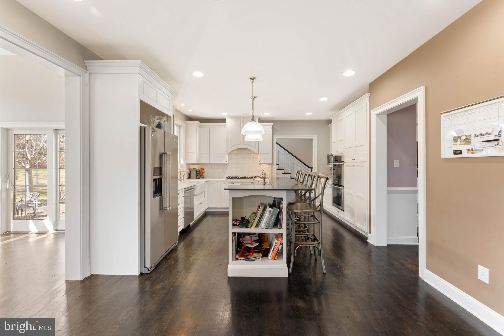 8 Quartermaster Road Feasterville-Trevose, PA 19053 - Photo 8 of 60 a view of kitchen with refrigerator microwave and wooden floor