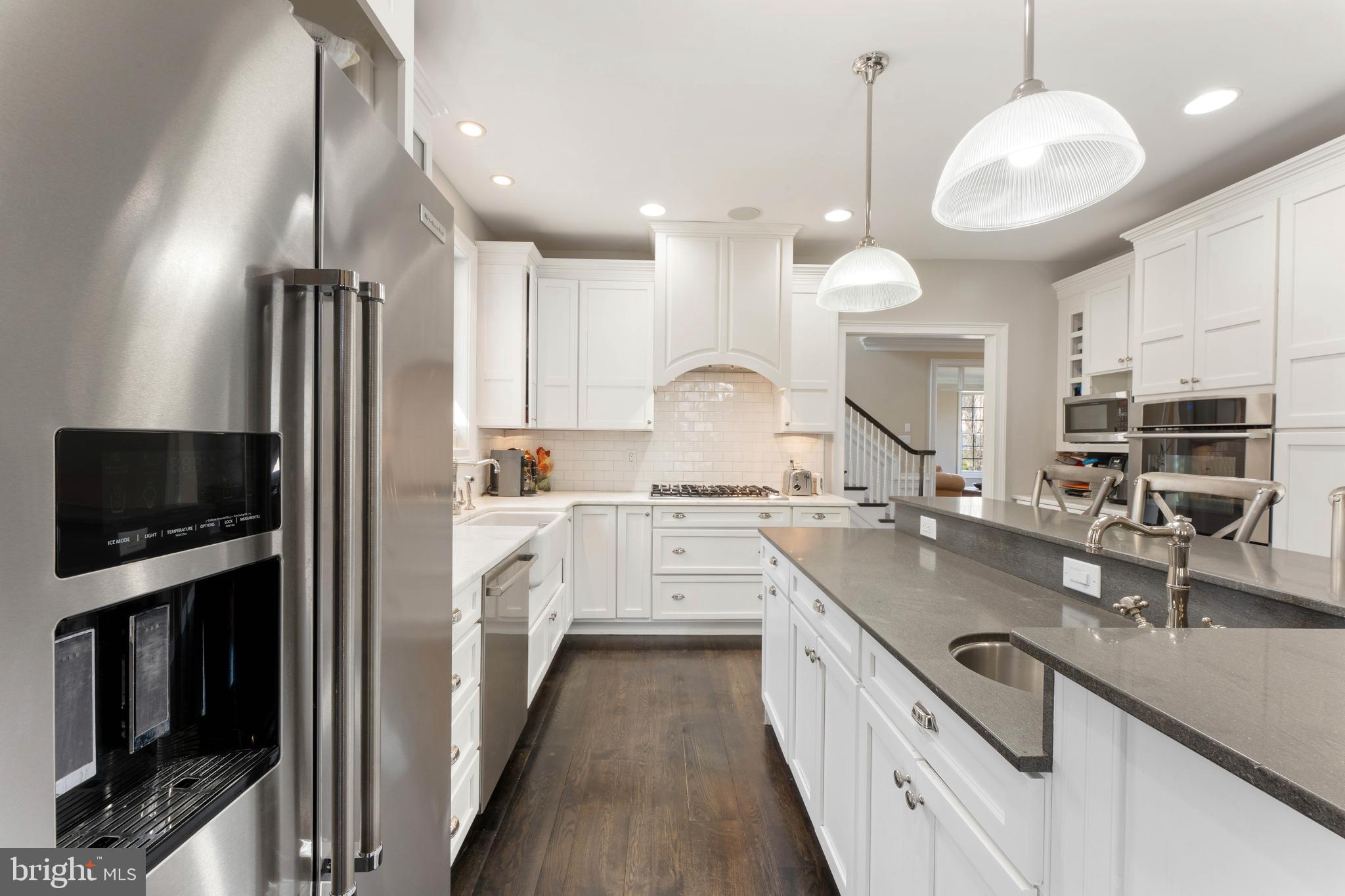 8 Quartermaster Road Feasterville-Trevose, PA 19053 - Photo 9 of 60 a kitchen with kitchen island granite countertop a sink a counter space appliances and cabinets