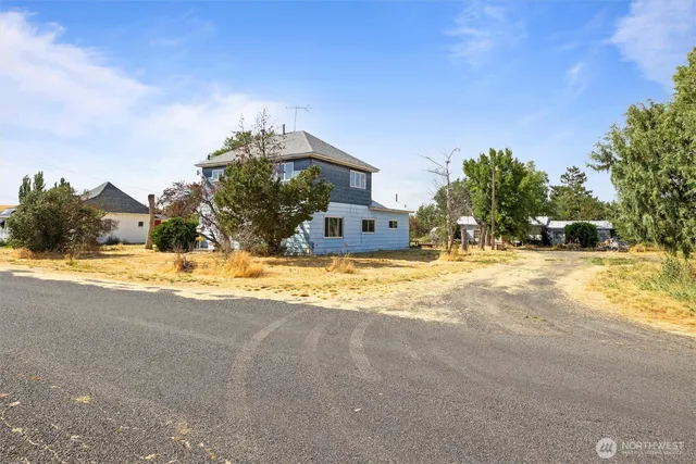 a view of a house with snow on the road