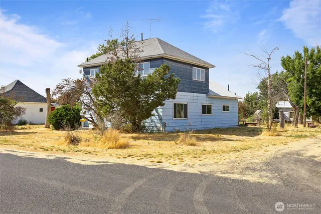 a view of a house with snow on the background