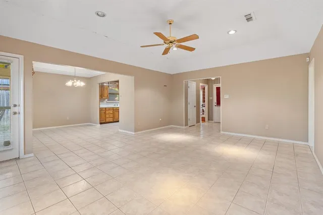 a view of a livingroom with a ceiling fan and entryway