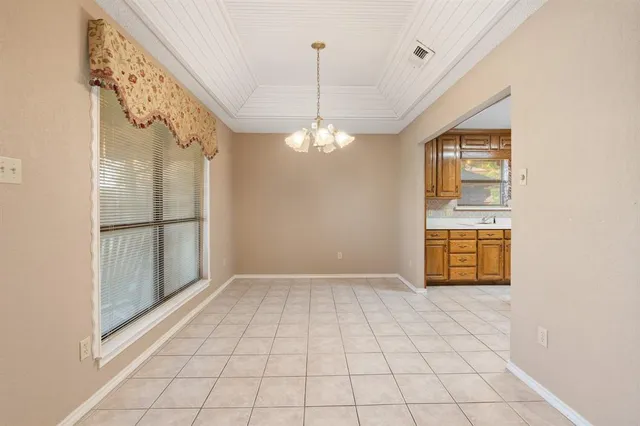 a view of a room with window chandelier and glass door