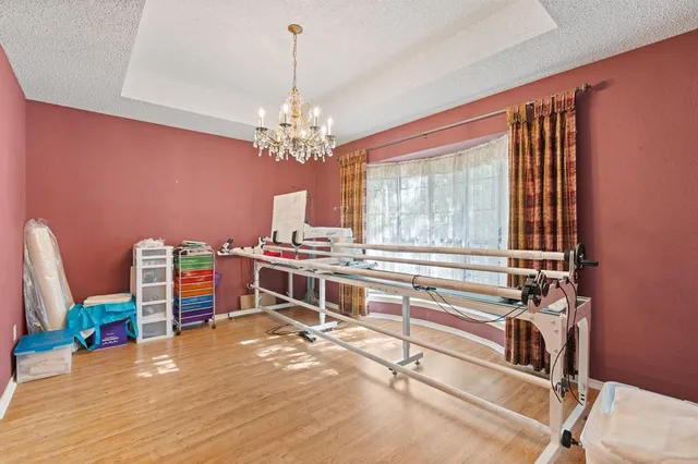 a room with a bed and a chandelier