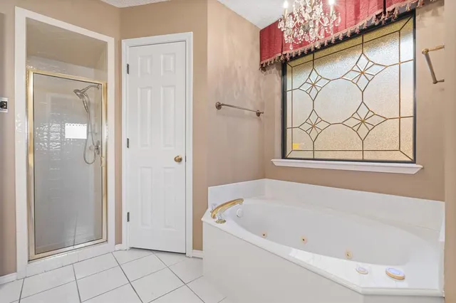 a white bath tub sitting next to a shower