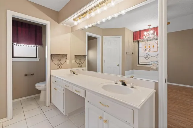 a bathroom with a sink a toilet and mirror