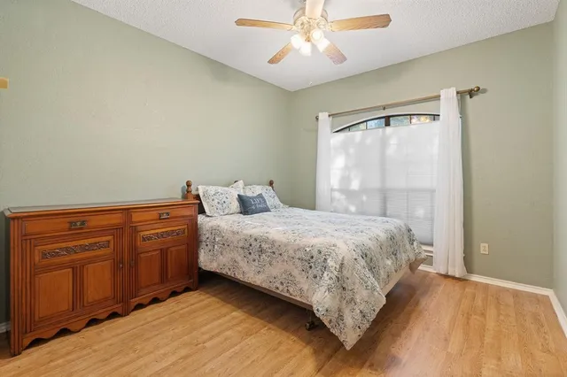 a bedroom with a bed dresser and a window
