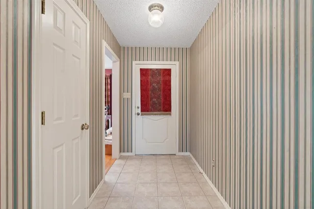 a view of a hallway with wooden shelves