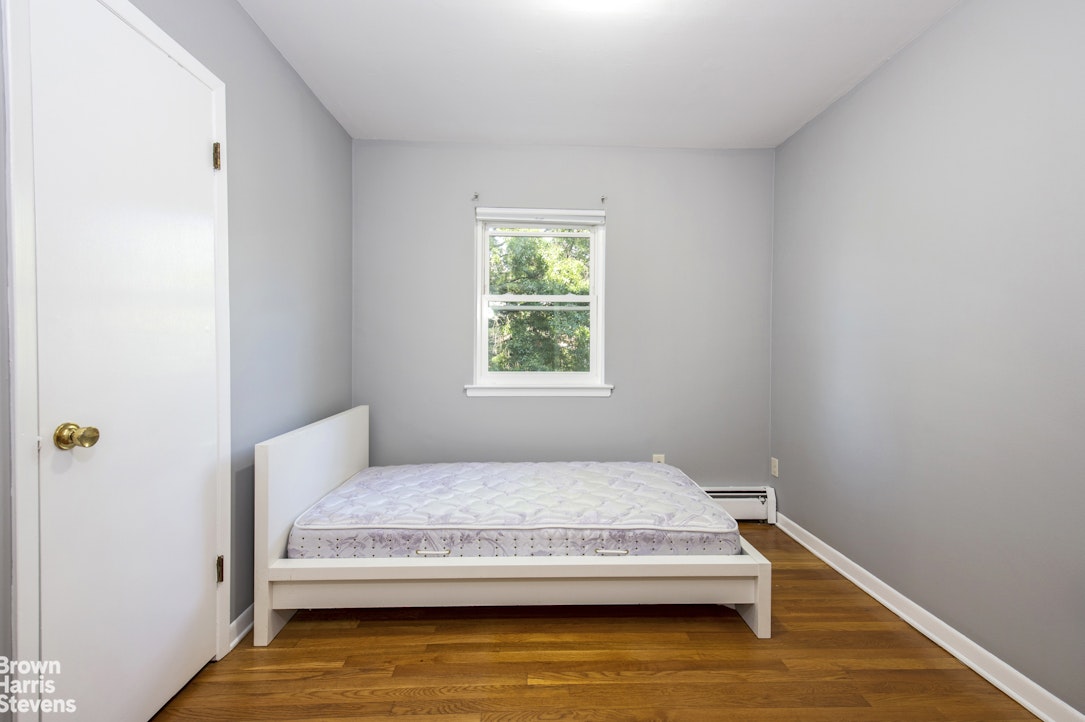 5834 Fieldston Road Bronx, NY 10471 - Photo 10 of 15 a bedroom with a bed and a window