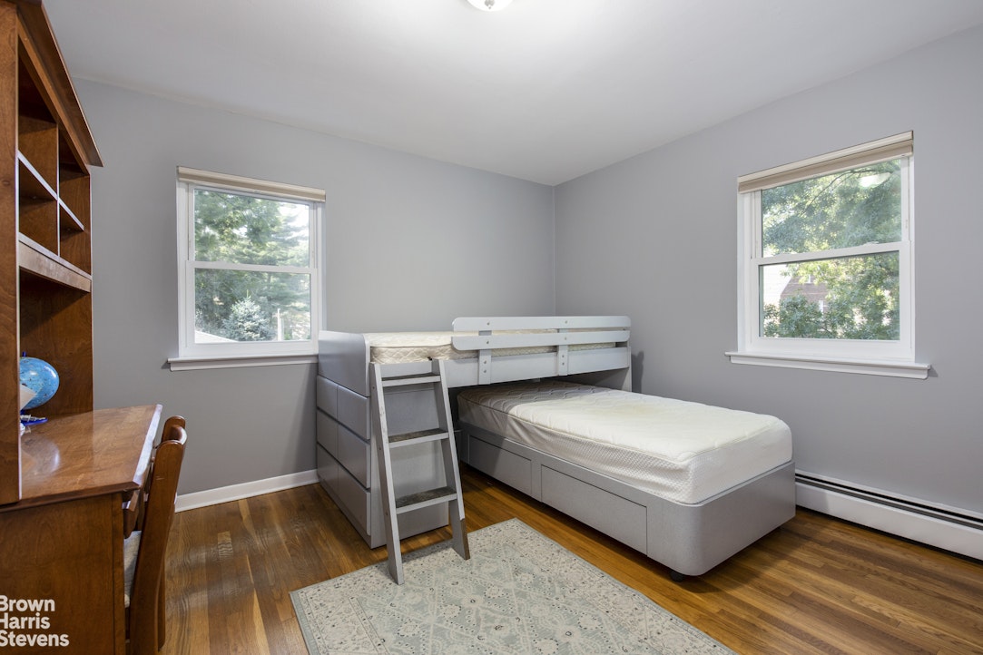 5834 Fieldston Road Bronx, NY 10471 - Photo 11 of 15 a bedroom with a bed and a window
