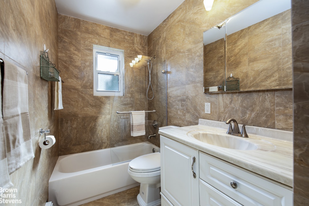 5834 Fieldston Road Bronx, NY 10471 - Photo 12 of 15 a bathroom with a sink a toilet and bathtub