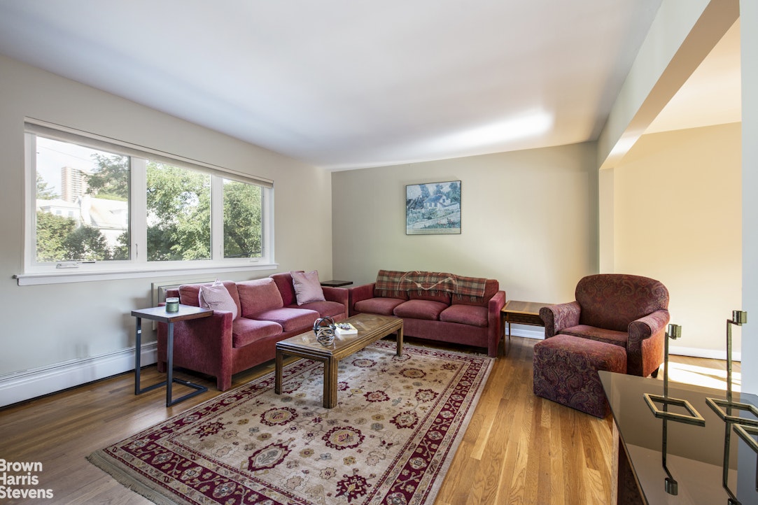 5834 Fieldston Road Bronx, NY 10471 - Photo 2 of 15 a living room with furniture and wooden floor