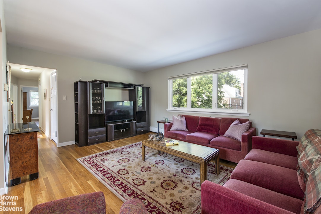 5834 Fieldston Road Bronx, NY 10471 - Photo 3 of 15 a living room with furniture and a flat screen tv