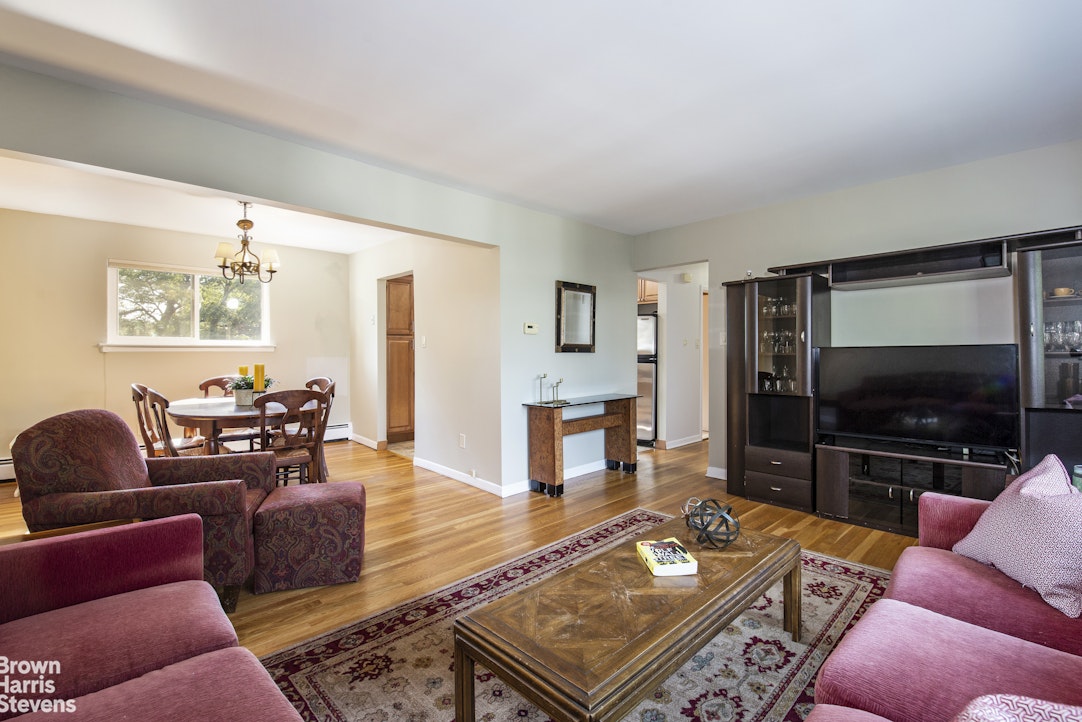 5834 Fieldston Road Bronx, NY 10471 - Photo 4 of 15 a living room with furniture and a flat screen tv