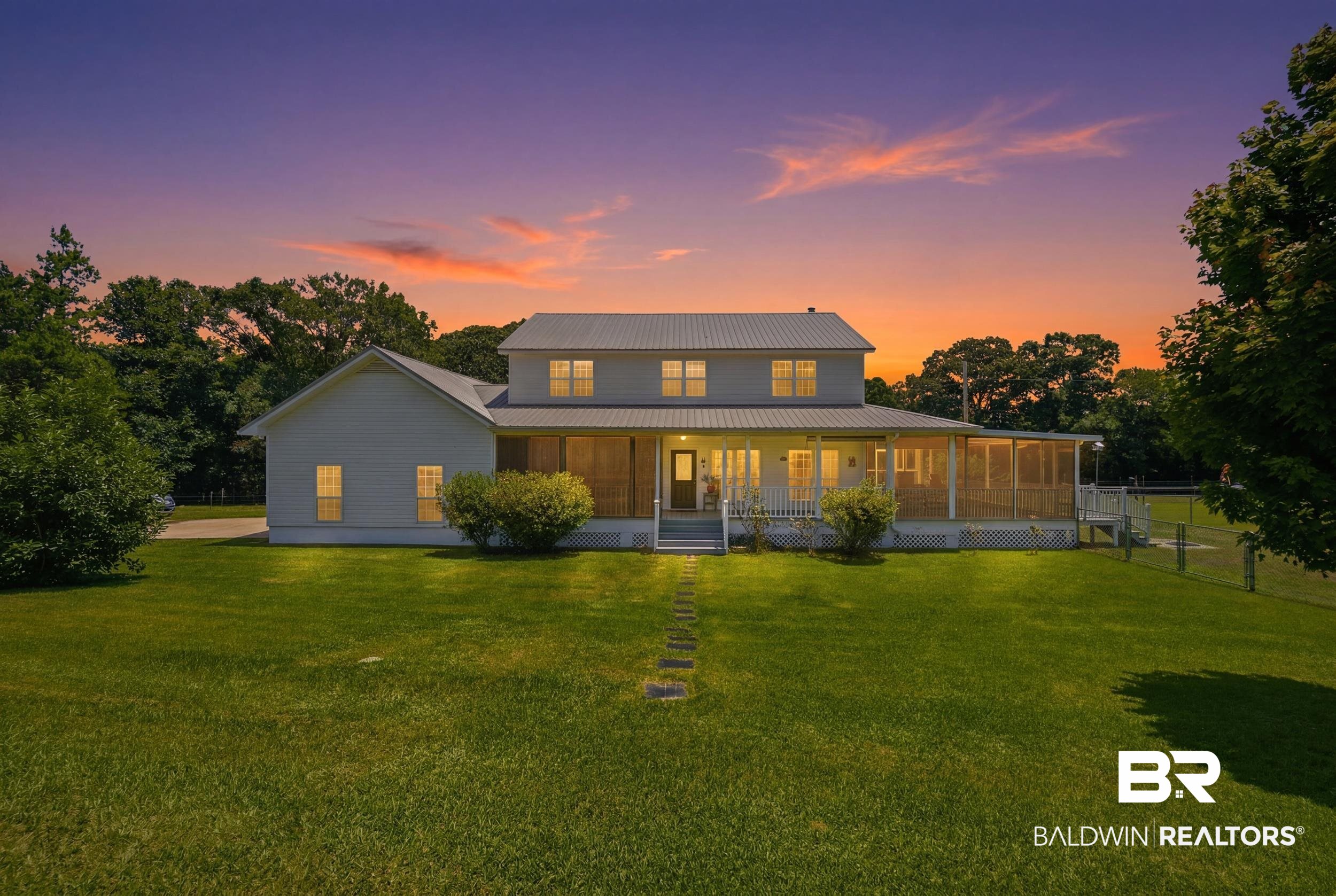 15855 Calvin Richerson Road Bay Minette, AL 36507 - Photo 1 of 83 Two-story residence featuring a gray metal roof, light-colored siding, and a full-width covered front porch