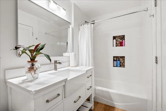a bathroom with a sink vanity granite tub and shower