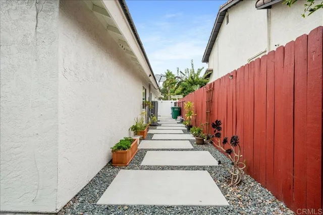 a view of a pathway with a potted plants