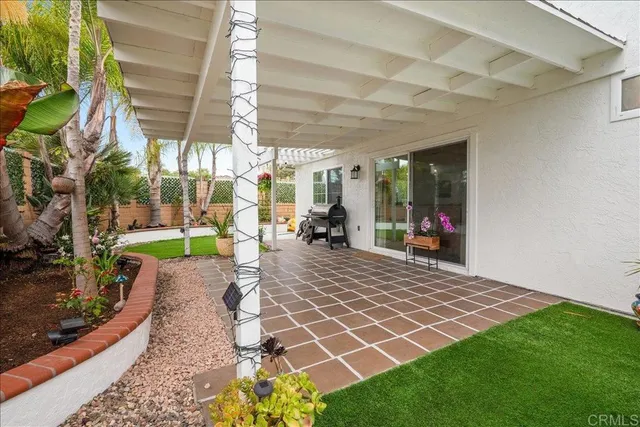 a view of a porch with a table and chairs