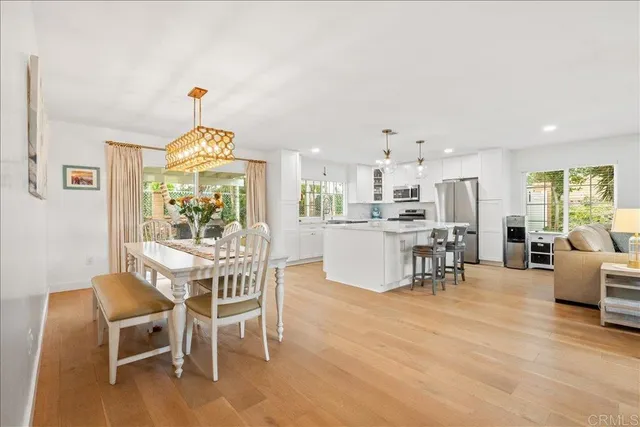 a view of a dining room with furniture and a chandelier