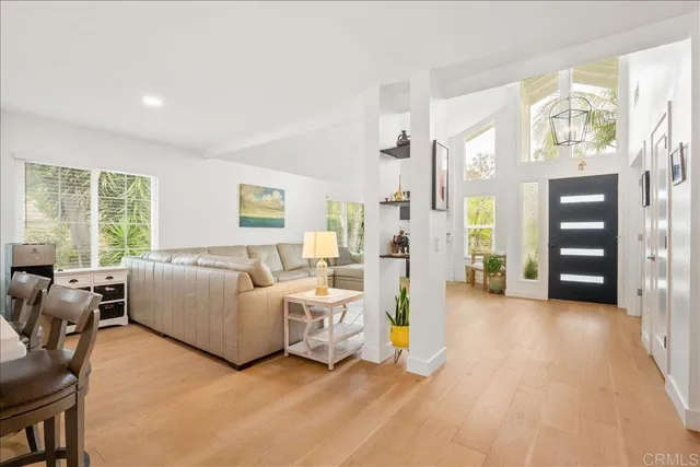 a living room with furniture and large window