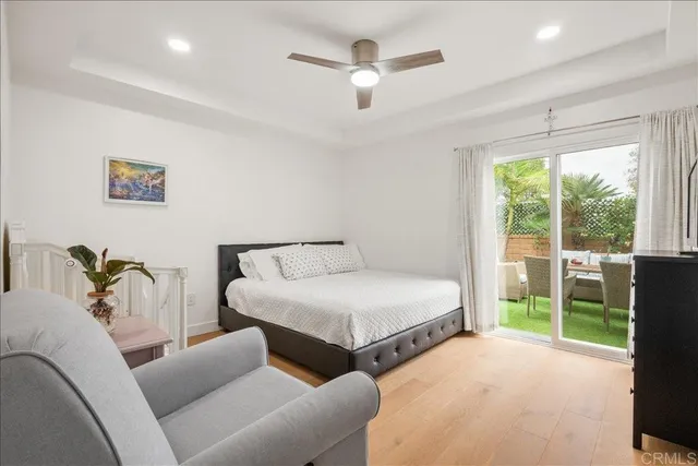 a bedroom with furniture and a large window