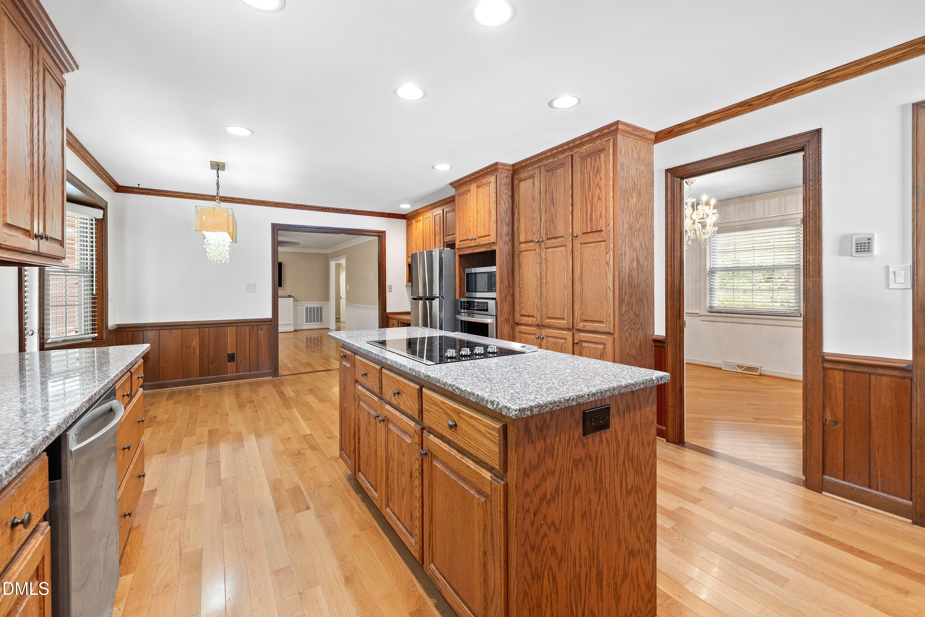 8133 Holly Forest Road Wake Forest, NC 27587 - Photo 14 of 50 a kitchen with granite countertop a sink and a stove top oven