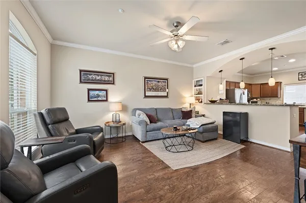 a living room with furniture and kitchen view