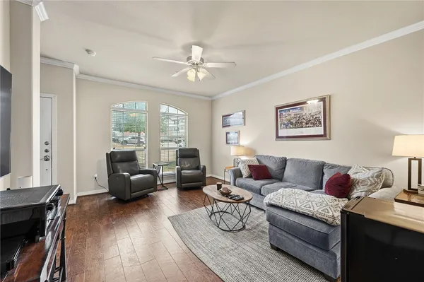 a living room with furniture and a wooden floor