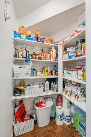 a cabinet with shelves and a wooden floor