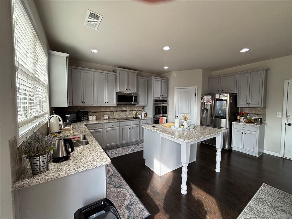 3459 In Bloom Way Auburn, GA 30011 - Photo 29 of 35 a kitchen with a refrigerator a stove a sink dishwasher a stove and white cabinets with wooden floor